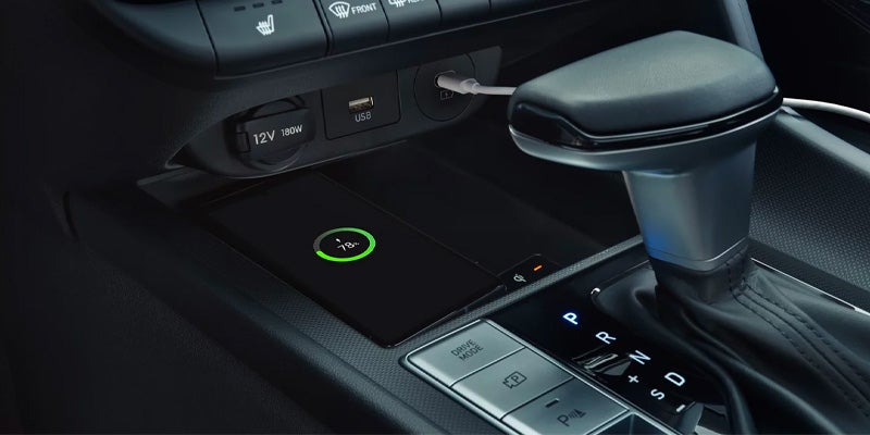 Interior center console featuring gear selector and wireless charging pad