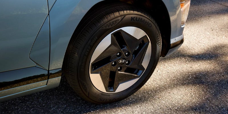 Close-up of a silver and black aerodynamic car wheel.