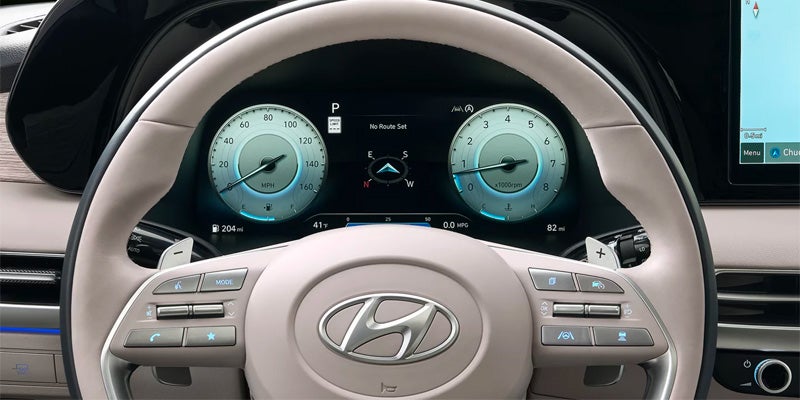 Interior view of a Hyundai Palisade's digital instrument cluster and steering wheel.