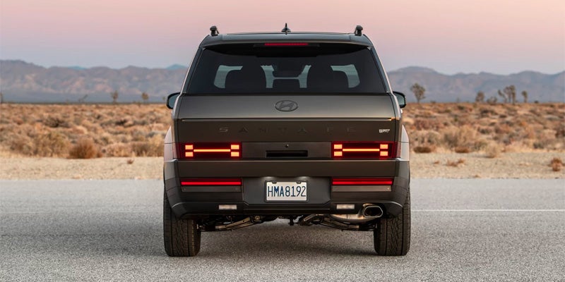 Direct rear view of a gray Hyundai Santa Fe on asphalt.