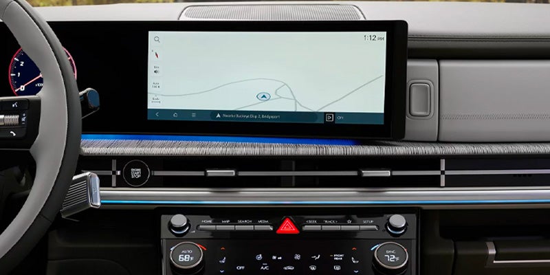 Close-up of a wide digital touchscreen infotainment and navigation display.