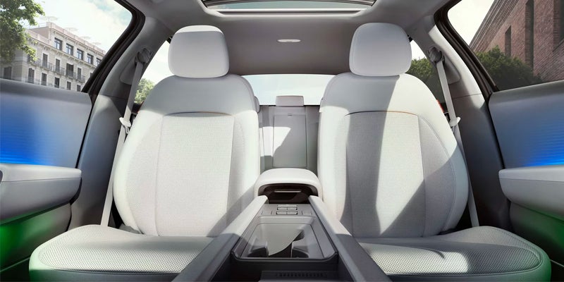 View of the front white leather seats and center console