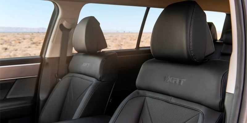Interior view of black leather SUV seats and rear passenger cabin.