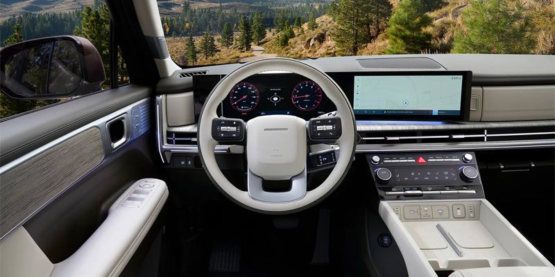 Wide view of a modern SUV dashboard with white steering wheel.
