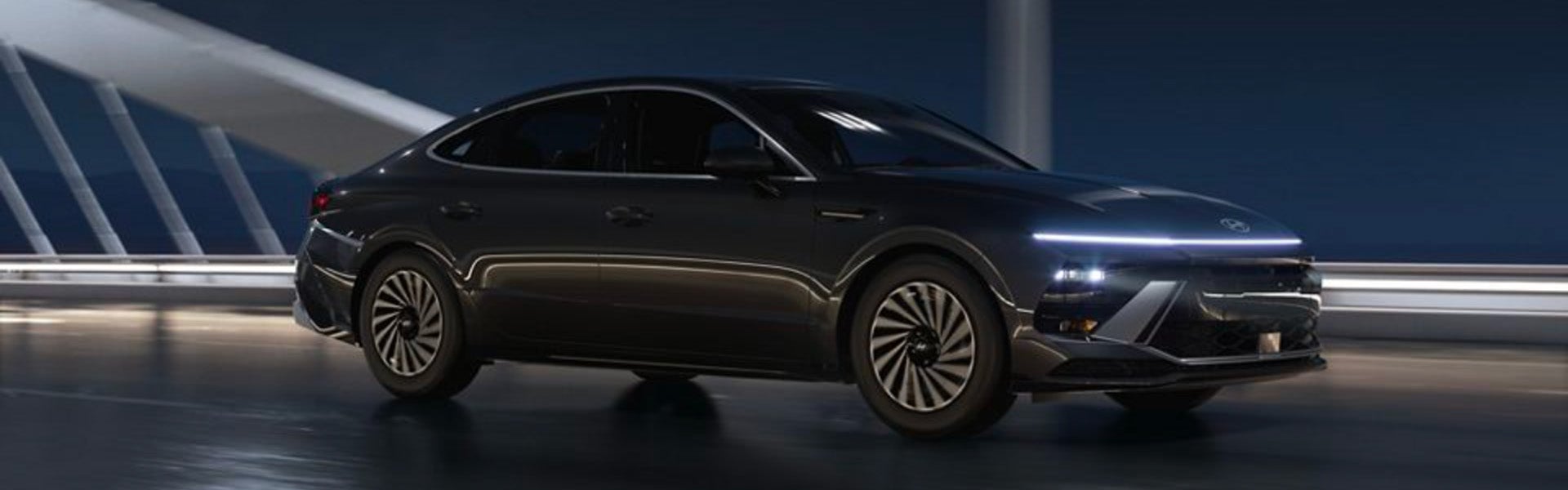 Gemini said A sleek dark gray Hyundai sedan driving on a bridge at night