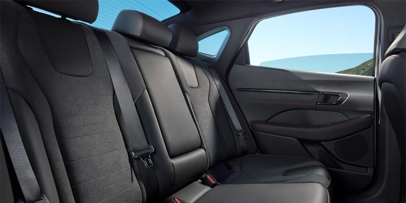 Interior view of the spacious black leather rear passenger seats.