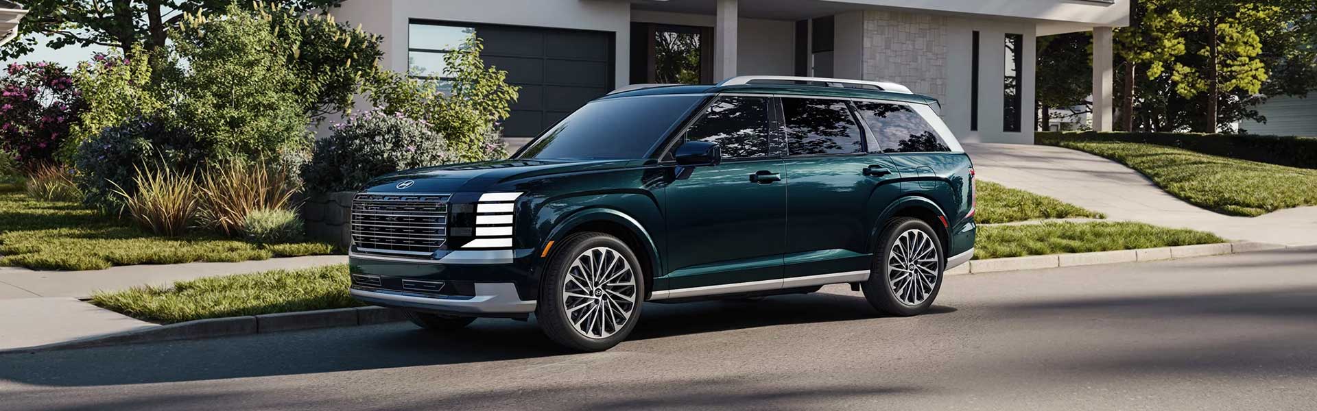 Dark green Hyundai Palisade SUV parked on a sunny suburban street