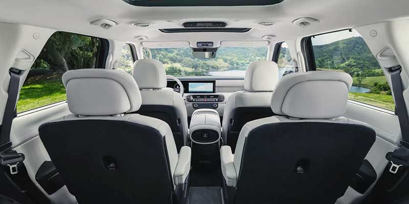 View of the spacious rear passenger seating area with white leather.